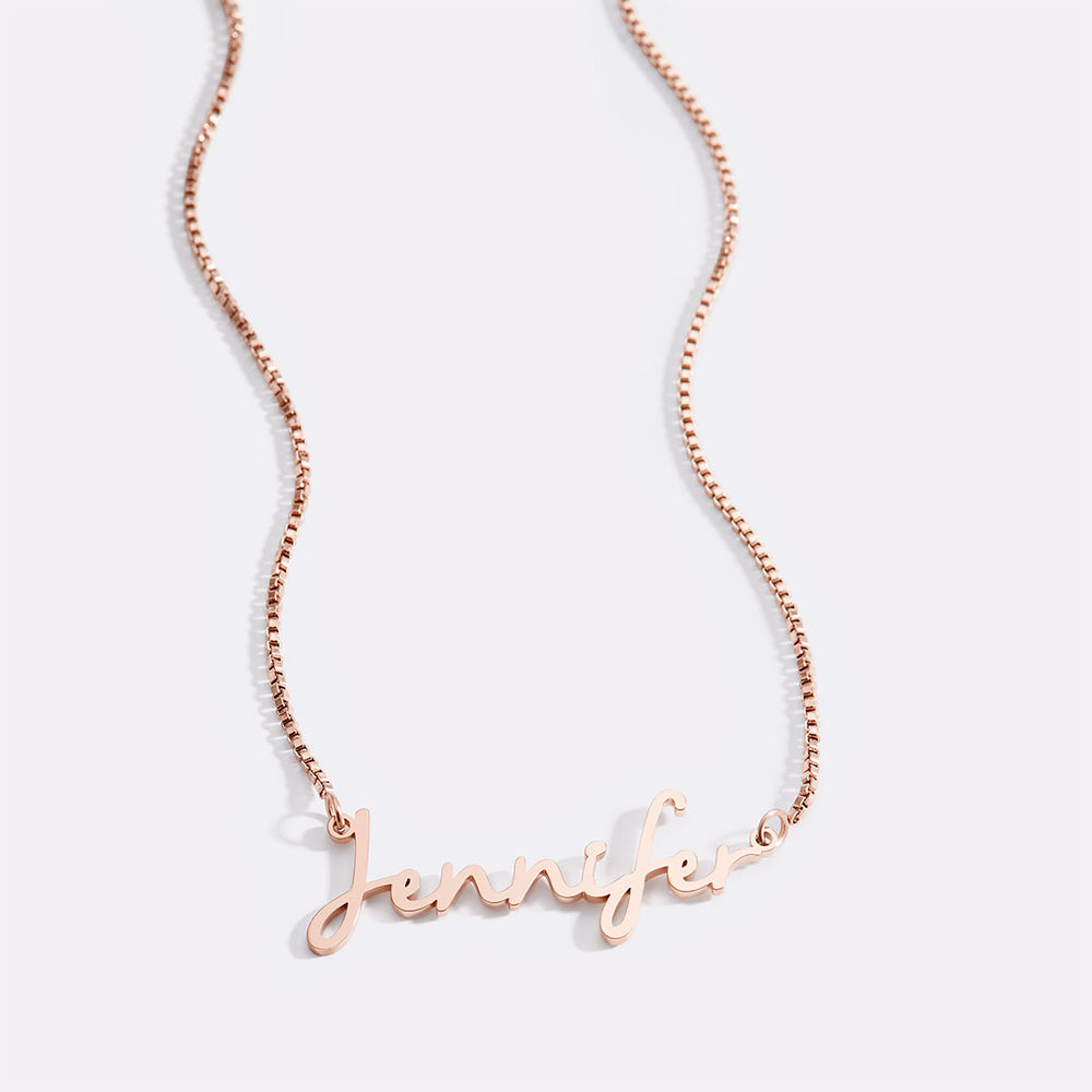 Rose gold name necklace on a white background