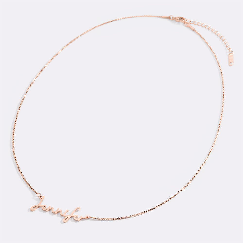 Rose gold necklace with 'Jenny' on a white background