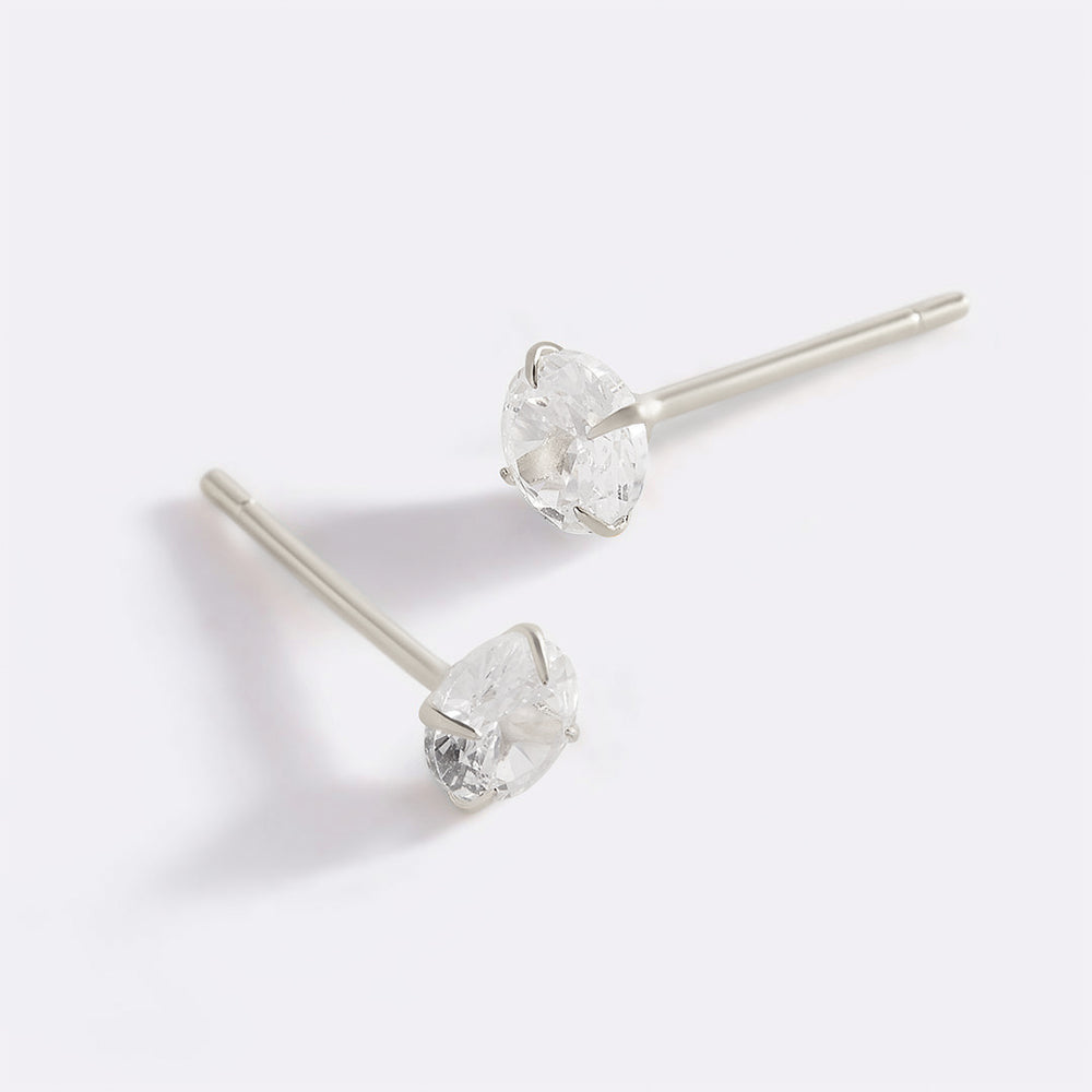A pair of classic round solitaire stud earrings with gold vermeil casing and cubic zirconia stones.