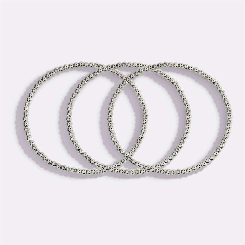 Three silver beaded bracelets on a light gray background