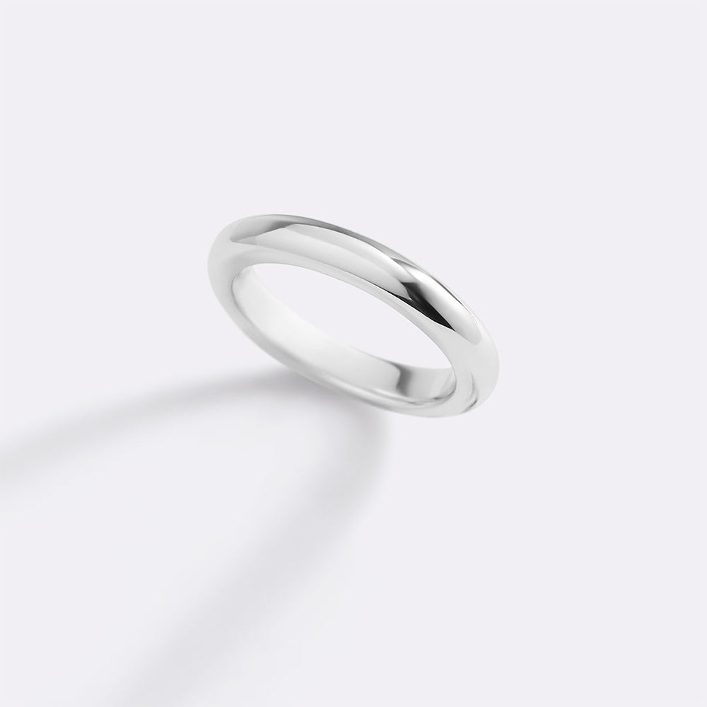 Silver ring on a light gray background