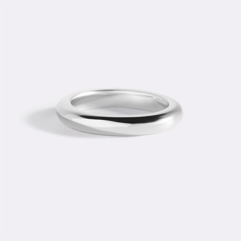 Silver ring on a light gray background