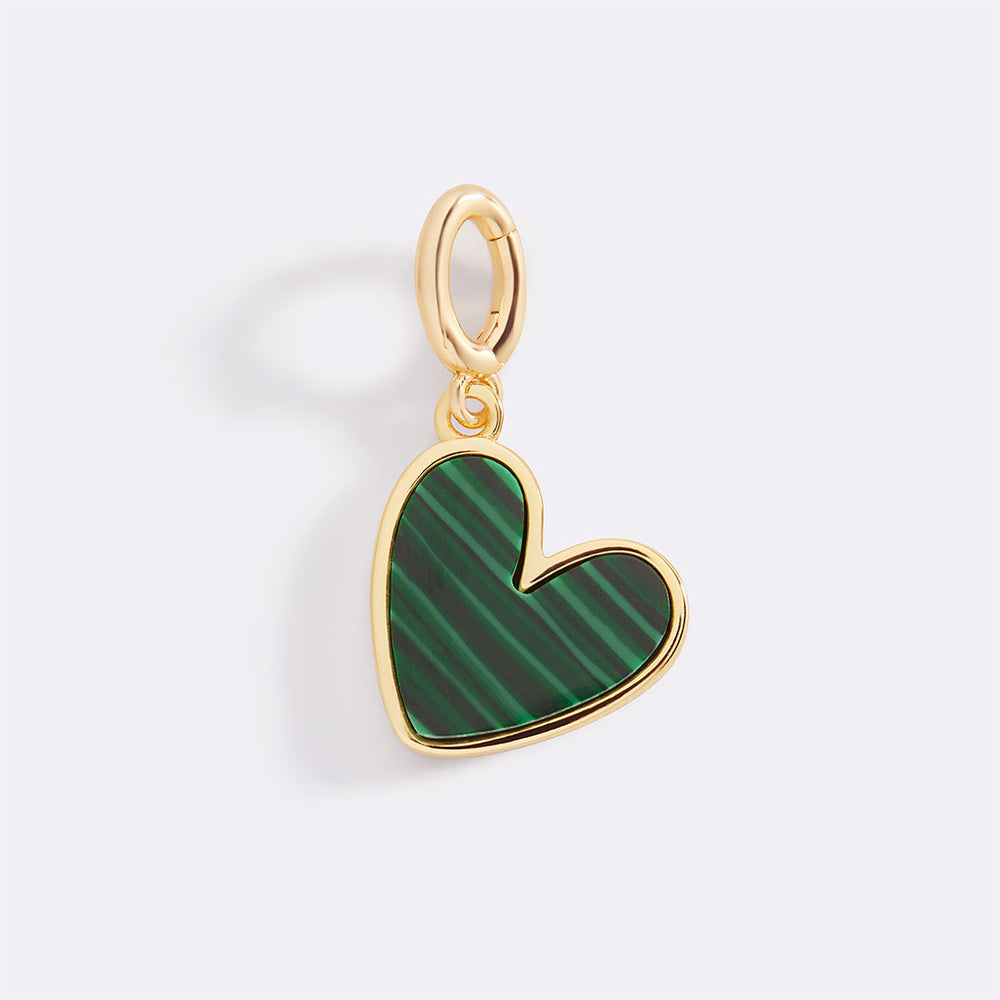 Heart-shaped pendant with green pattern and gold frame on a light gray background