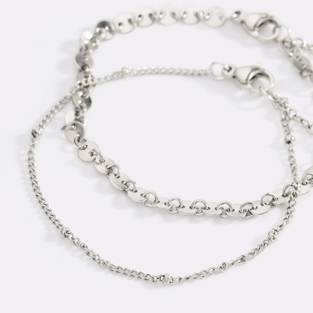 Two silver chain bracelets on a white background