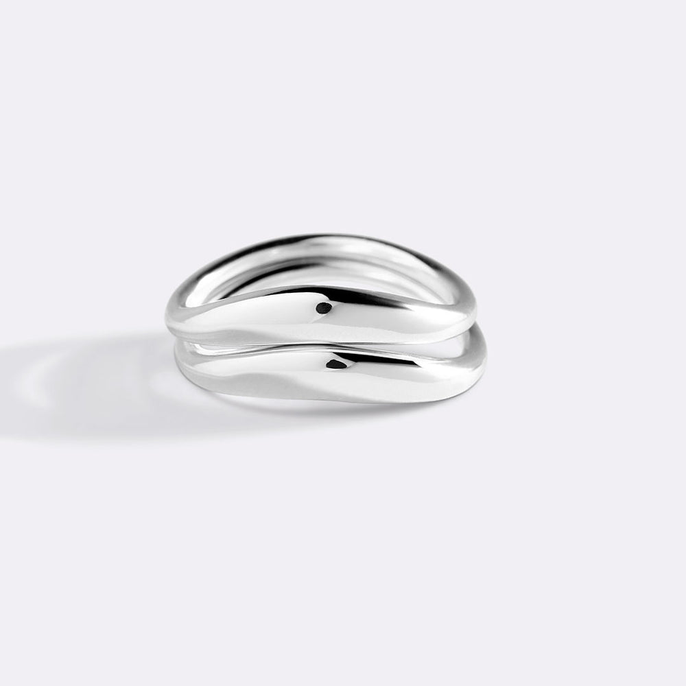 Silver ring on a light gray background
