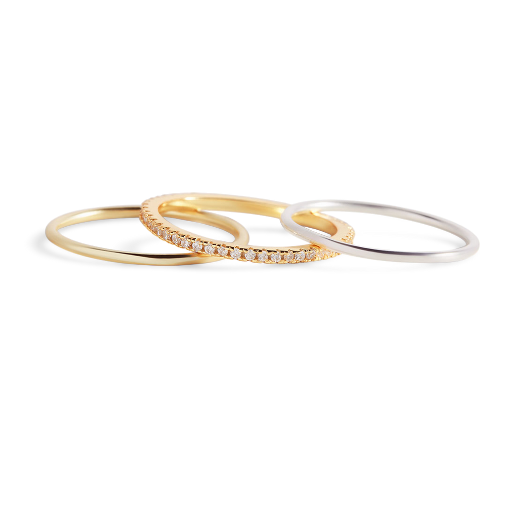 Three gold rings with diamond accents on a white background