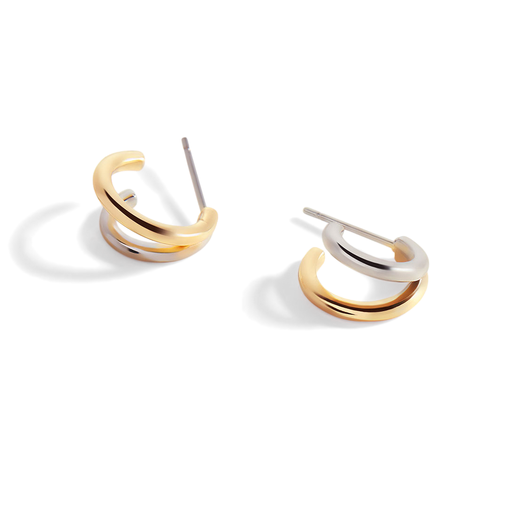 Pair of gold and silver hoop earrings on a white background