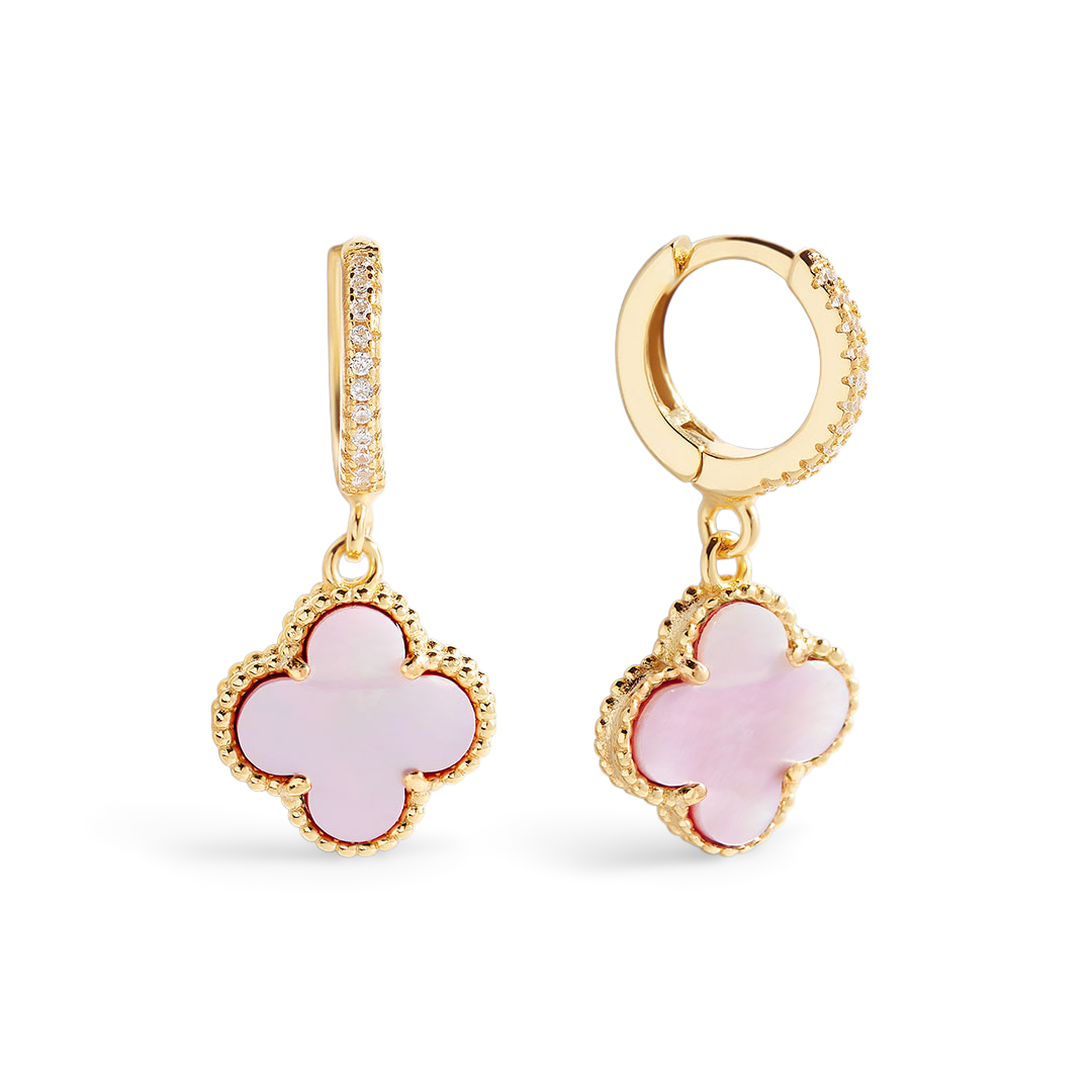 Gold and pink earrings on a white background