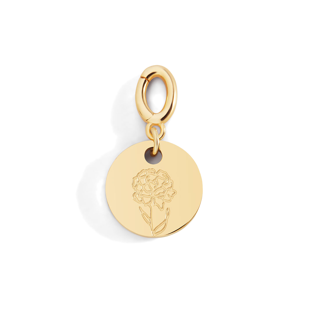 Gold pendant with a floral design on a light gray background