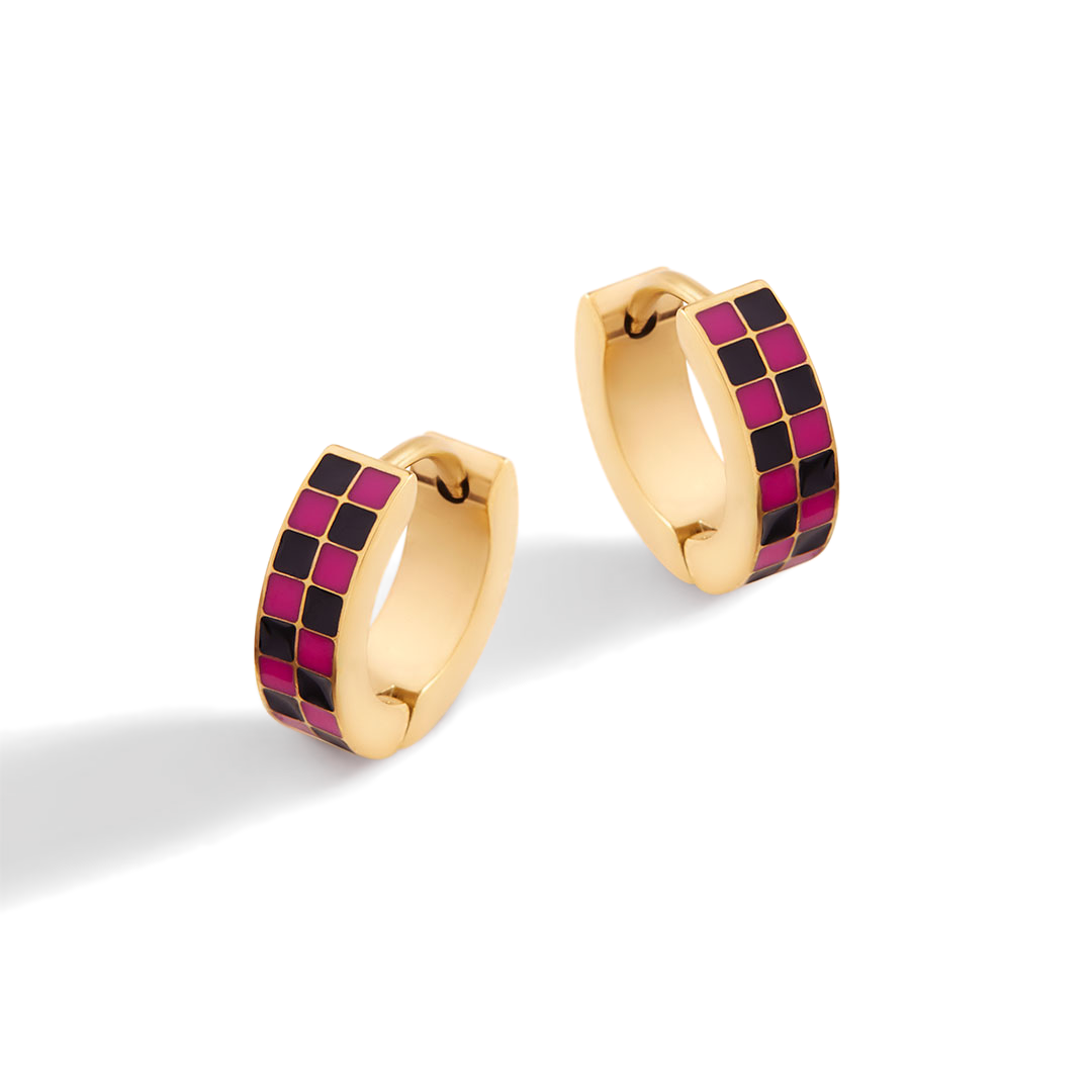 Gold hoop earrings with pink and black checkered pattern on a white background