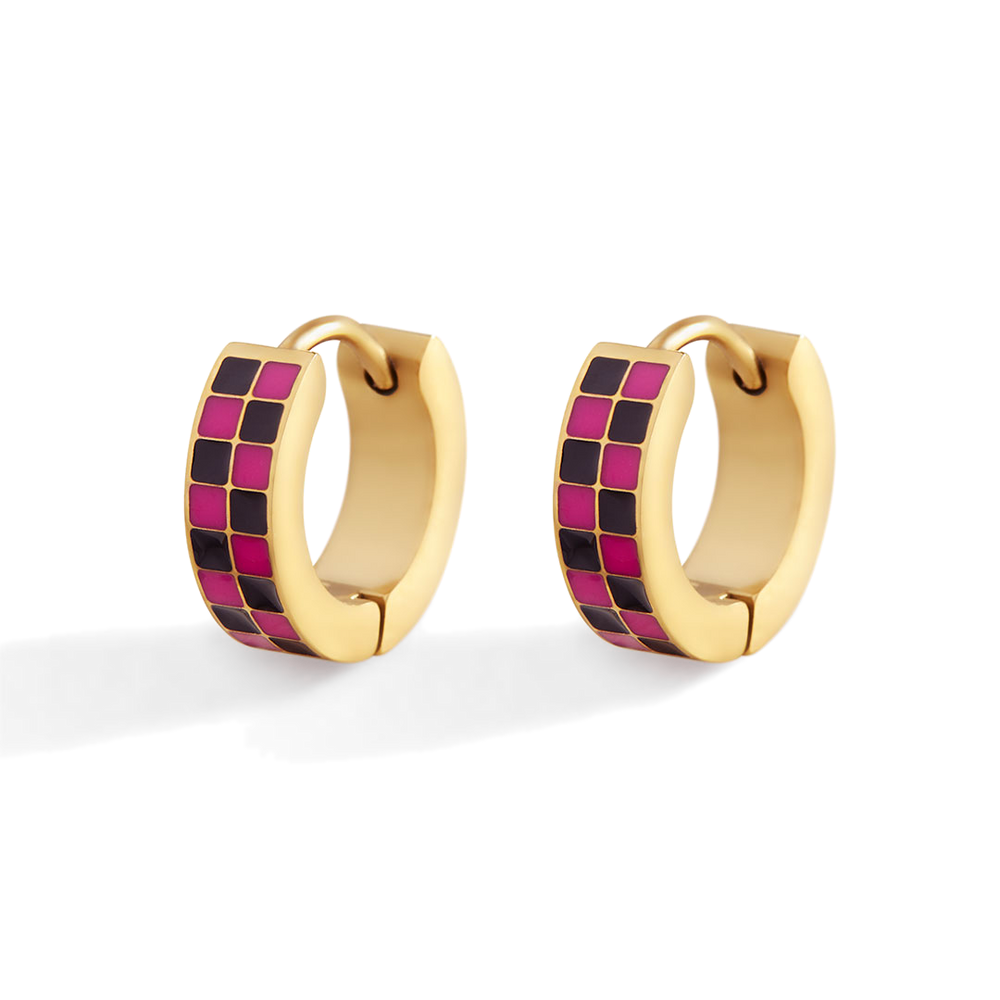 Gold hoop earrings with pink and black checkered pattern on a white background