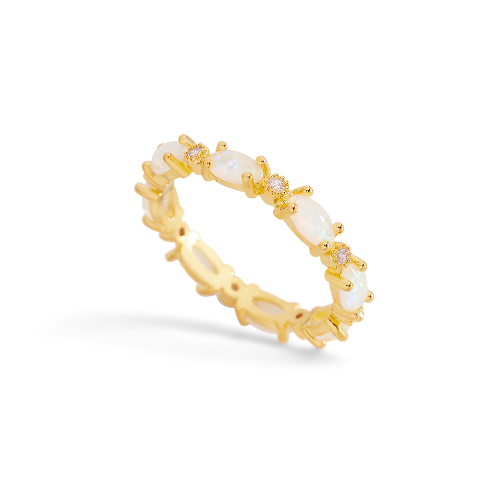 Gold ring with pearls on a light gray background