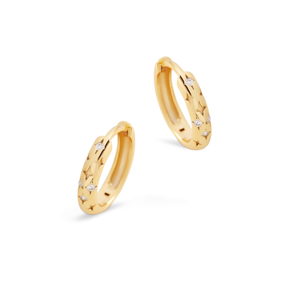 Gold hoop earrings with small diamonds on a light gray background