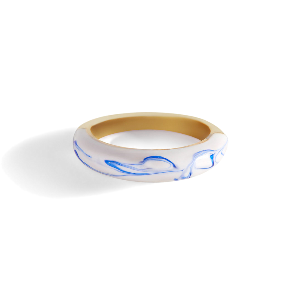 A blue porcelain dome ring with a gold band on a white background.