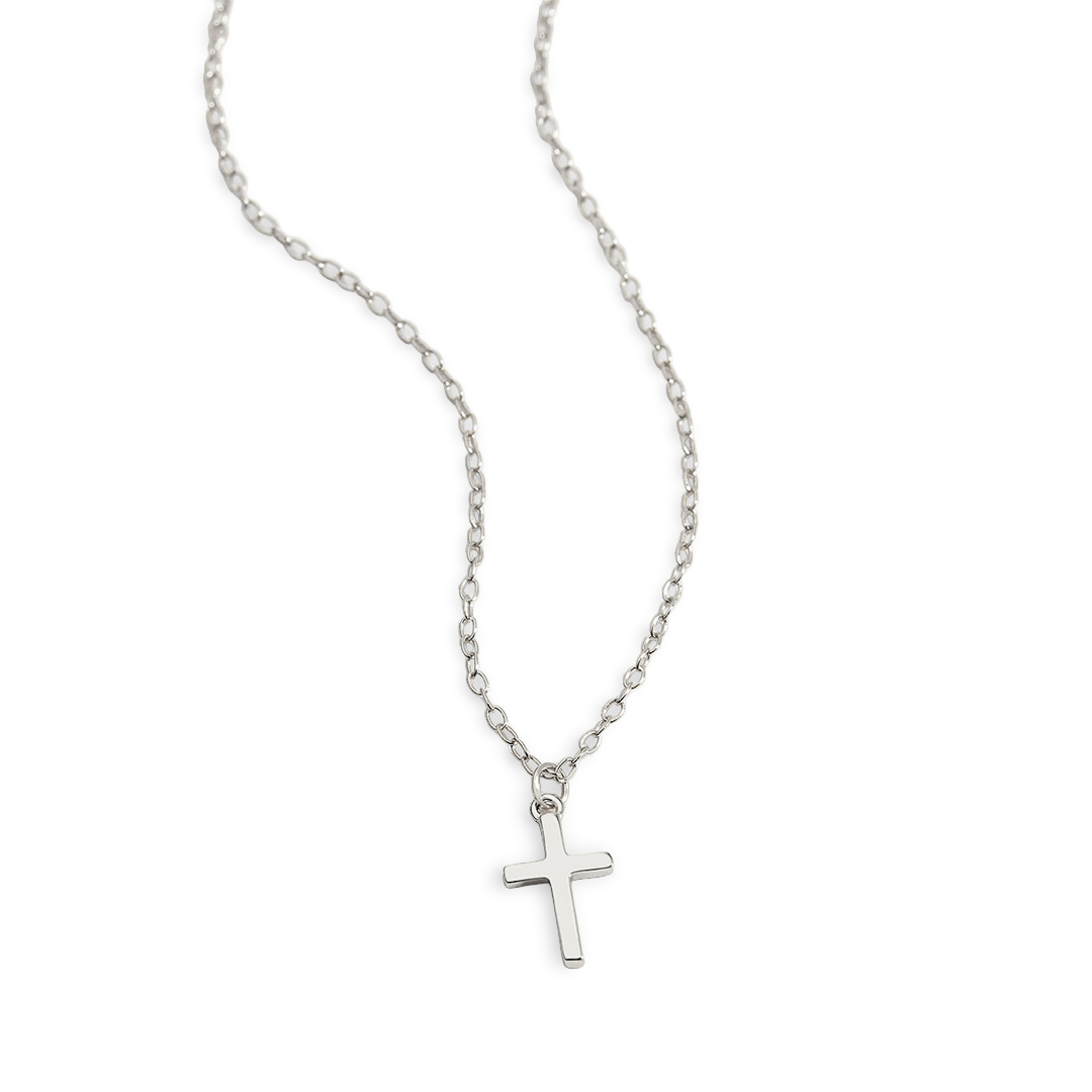 A gold-colored cross necklace with a dainty cable chain laid out against a plain background.