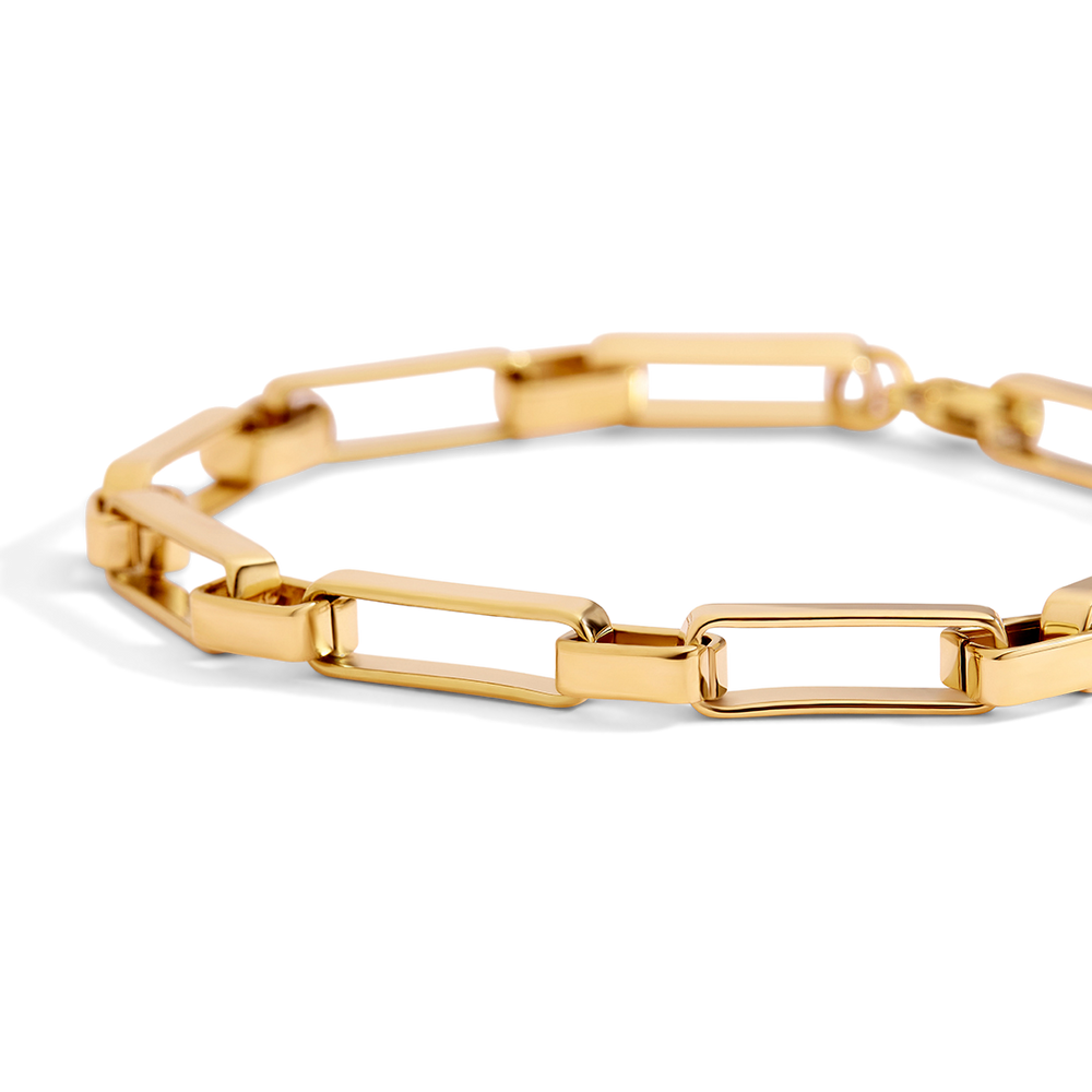 Gold bracelet on a light gray background