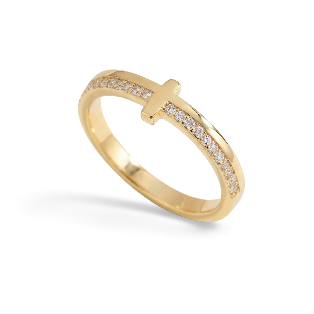 Gold ring with a cross design on a white background