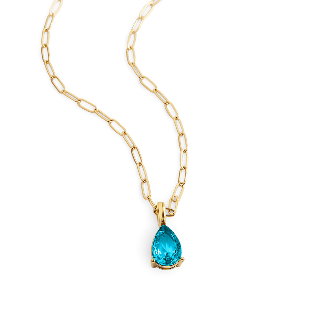 Gold necklace with a blue teardrop pendant on a white background
