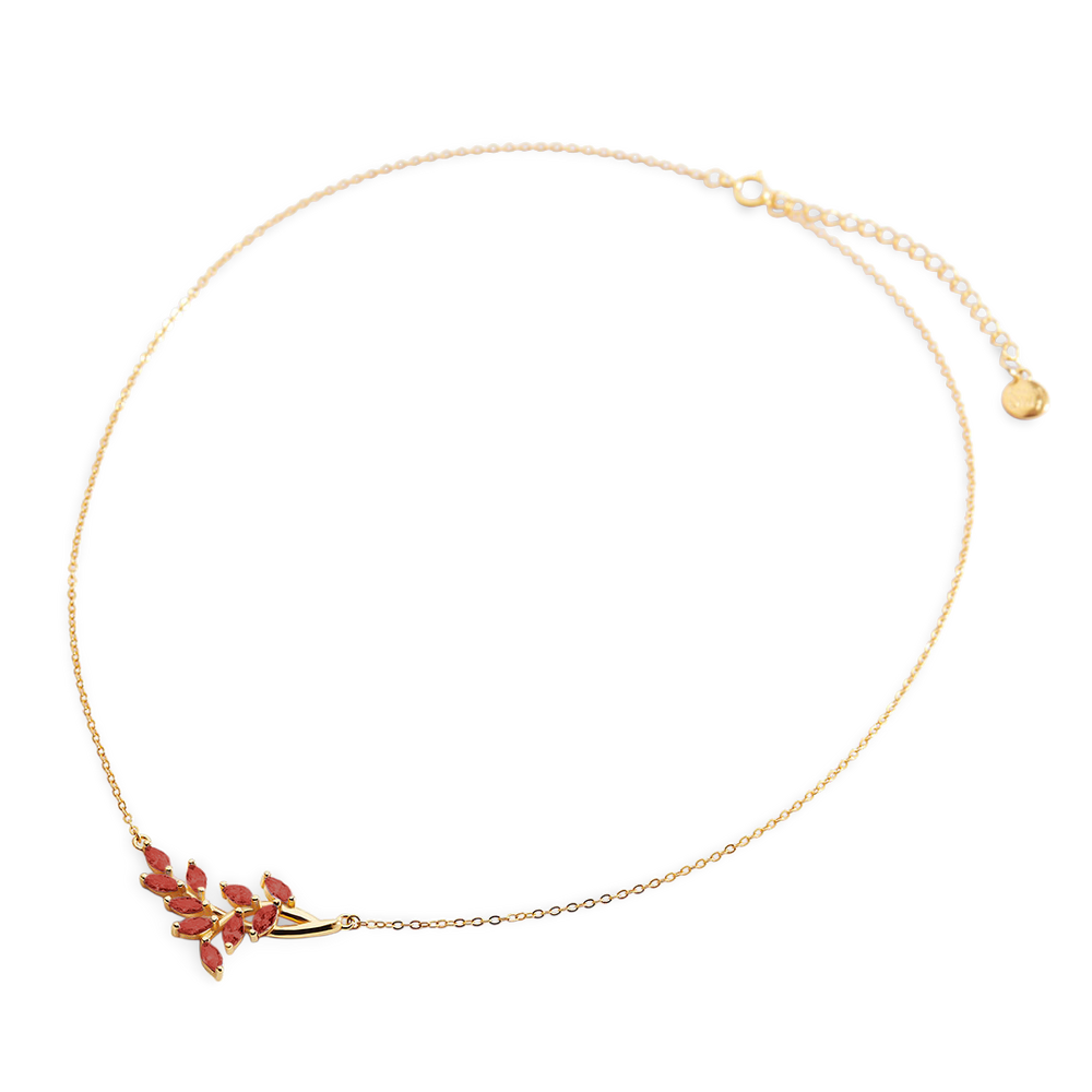 Gold necklace with a floral pendant on a light gray background