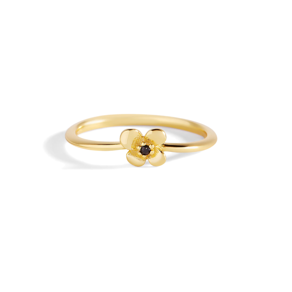 Gold ring with a small flower design on a white background