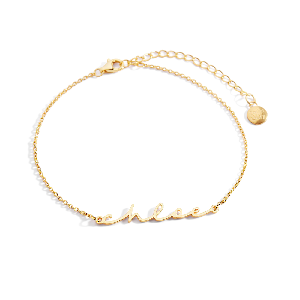 Gold bracelet with 'chloe' engraving on a white background