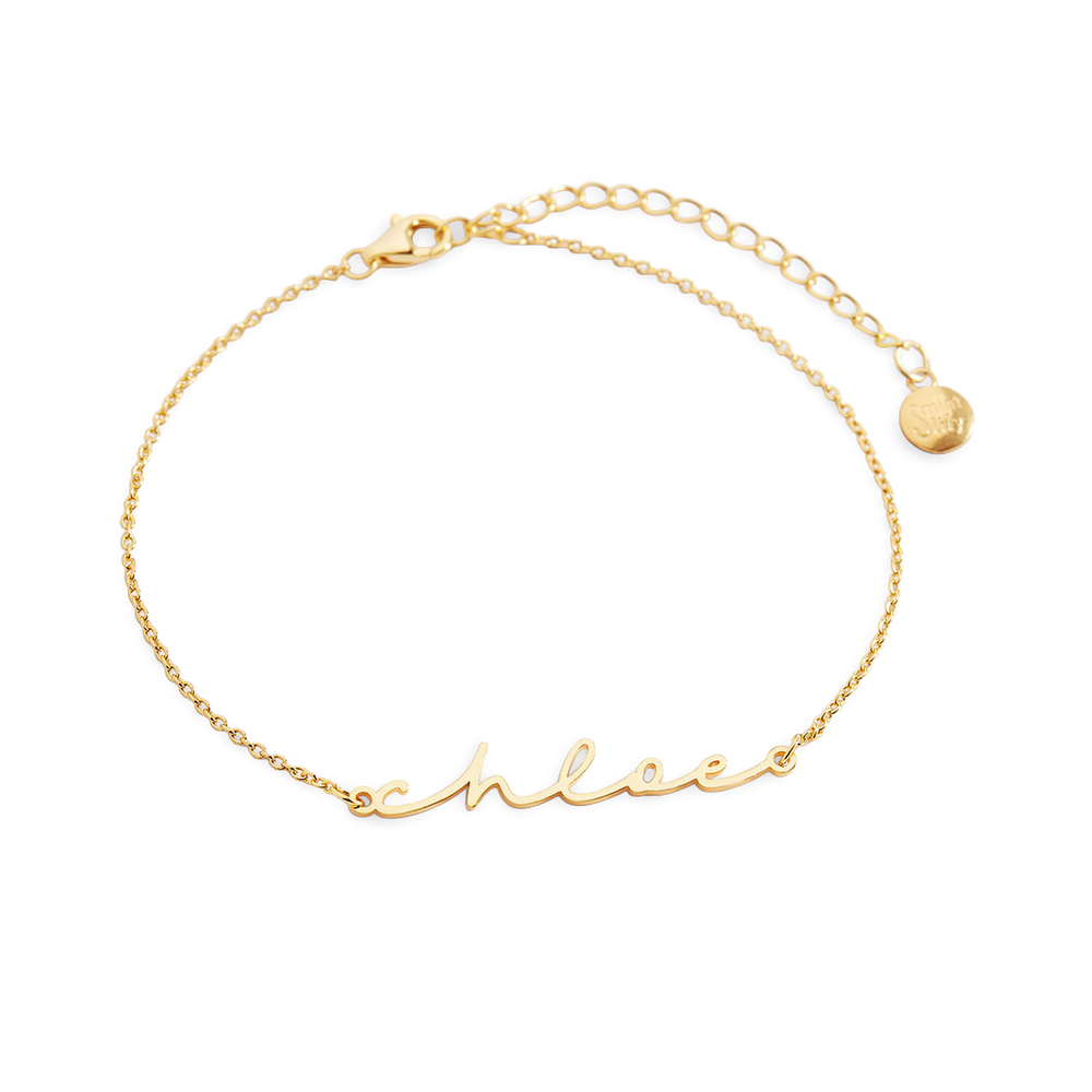 Gold bracelet with 'chloe' engraving on a white background
