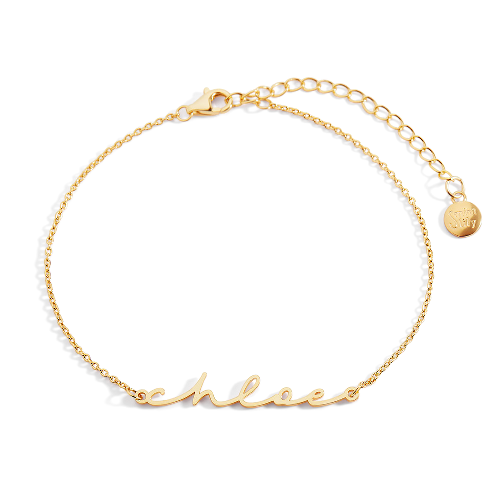 Gold bracelet with 'schnee' engraving on a light gray background