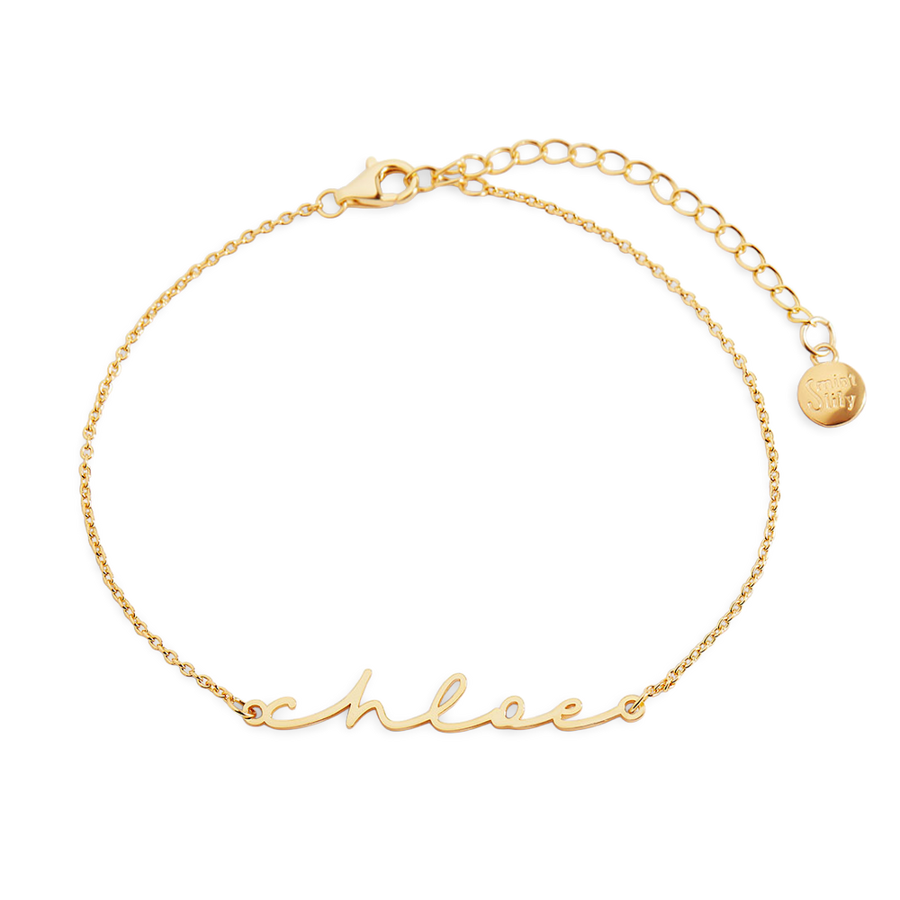 Gold bracelet with 'schnee' engraving on a light gray background