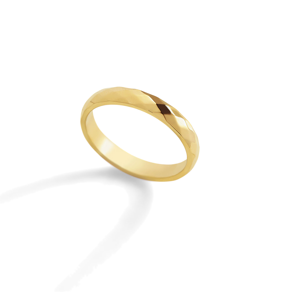 Gold ring on a light gray background