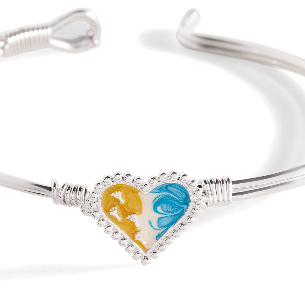 Silver bracelet with a heart-shaped charm featuring a colorful design on a white background