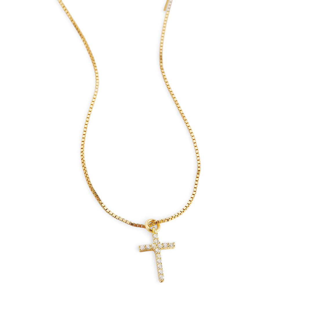 Gold necklace with a cross pendant on a light gray background