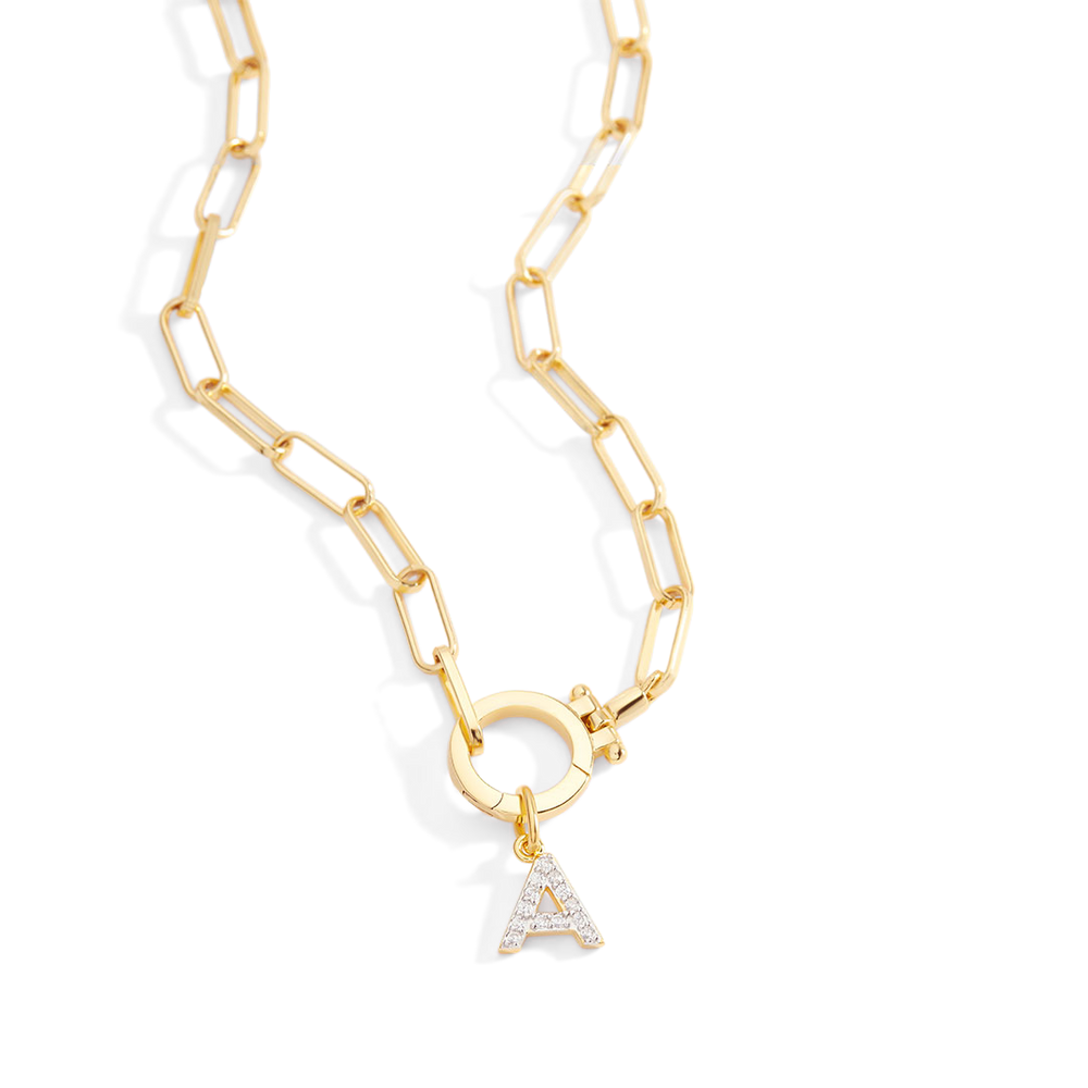 Gold chain necklace with a diamond-studded 'A' pendant on a light gray background