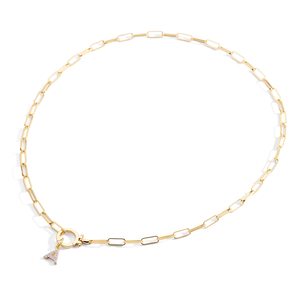 Gold chain necklace on a light gray background