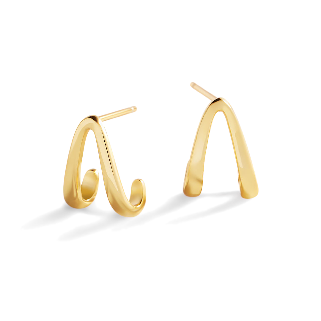 Gold hoop earrings on a light gray background
