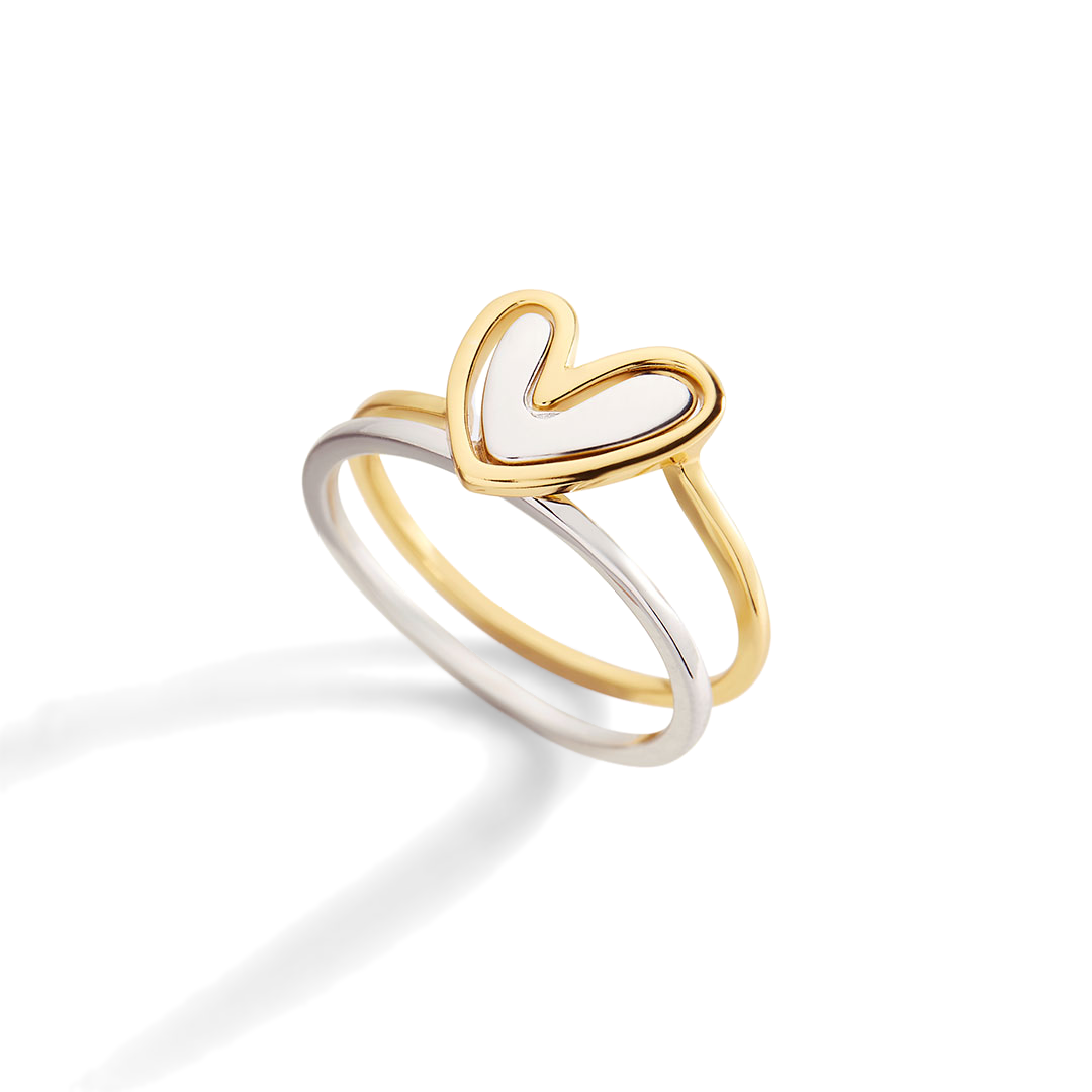 Two heart-shaped rings, one gold and one silver, on a light gray background.