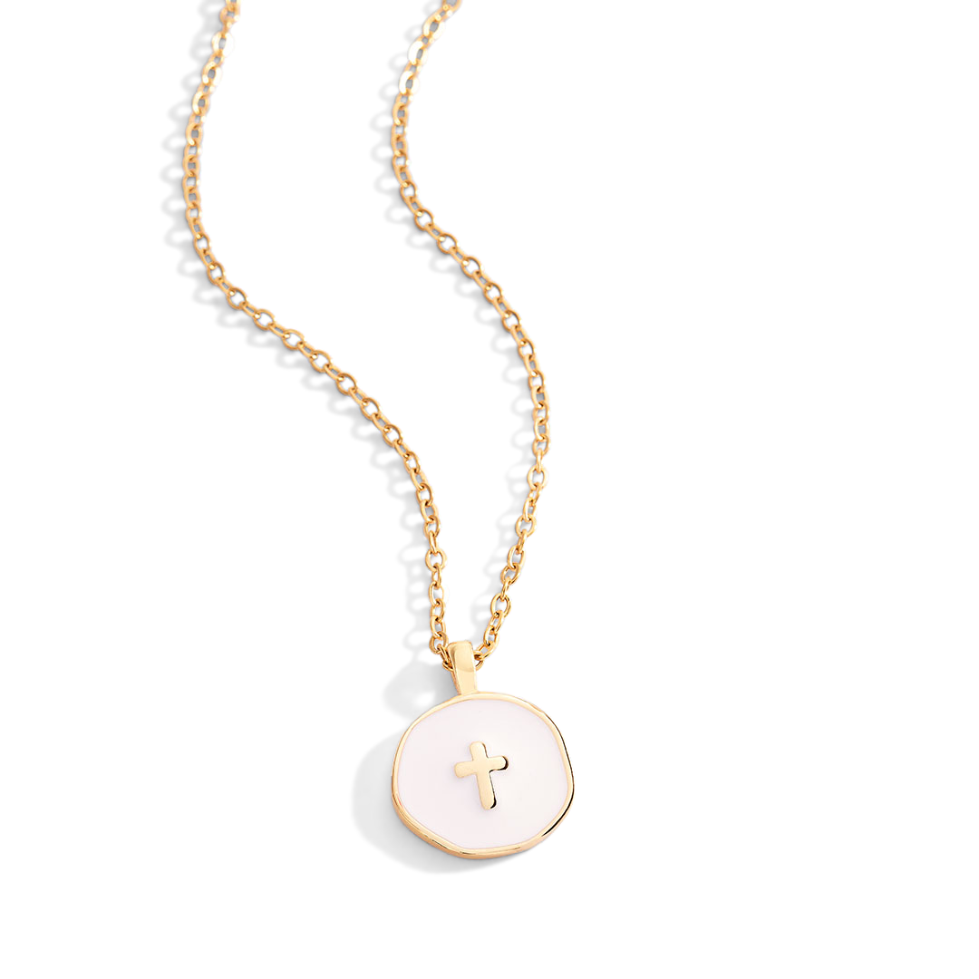 Gold necklace with a round pendant featuring a cross on a light gray background