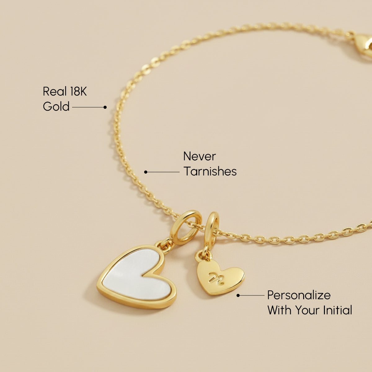 Gold necklace with heart-shaped charms on a beige background
