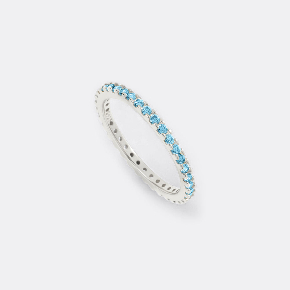 Silver ring with blue gemstones on a white background