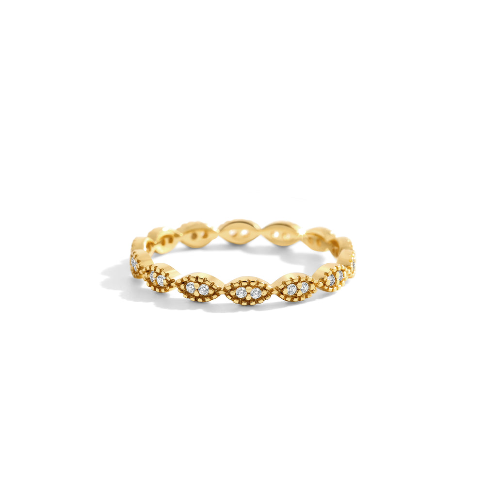 Gold ring with intricate design on a white background