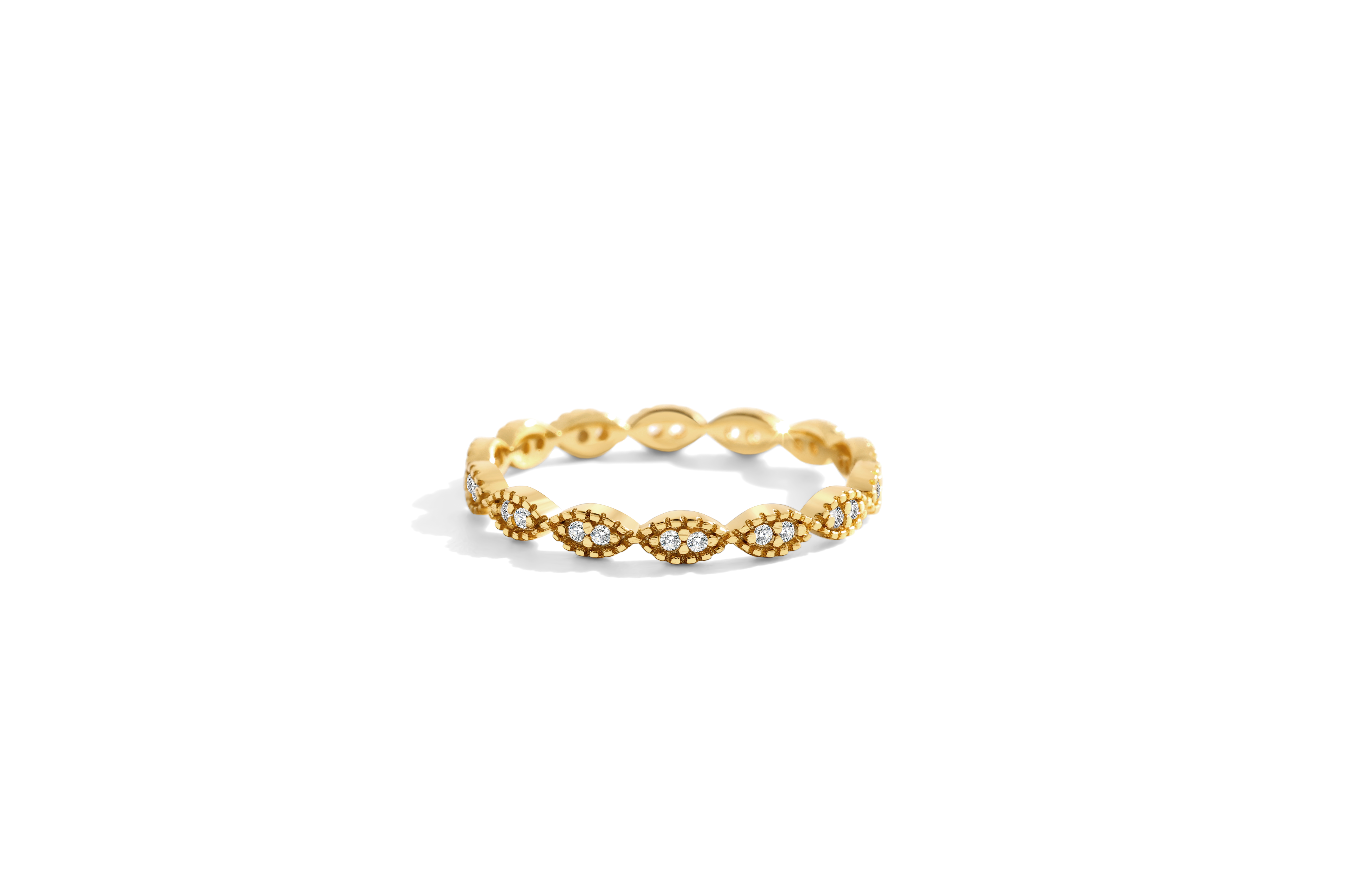 Gold ring with intricate design on a white background