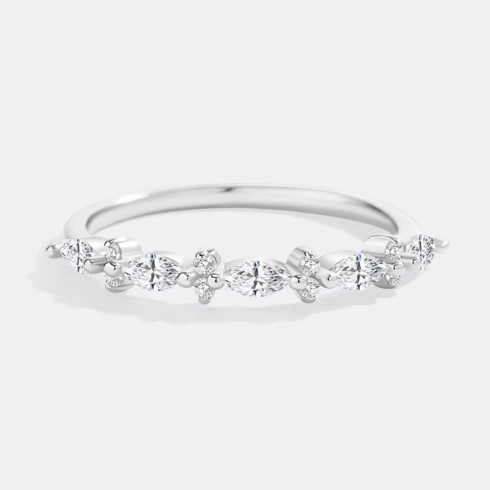 Silver ring with multiple diamonds on a light gray background