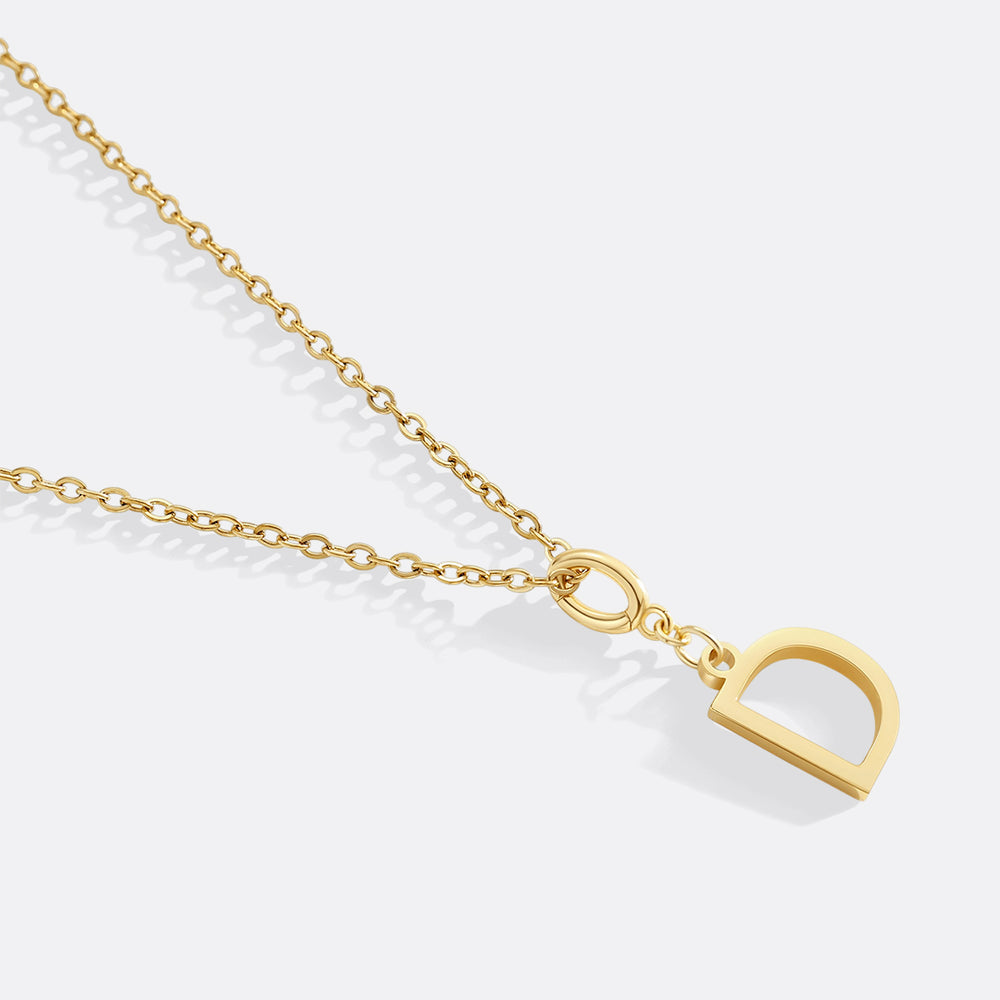 Gold necklace with a heart-shaped pendant on a white background