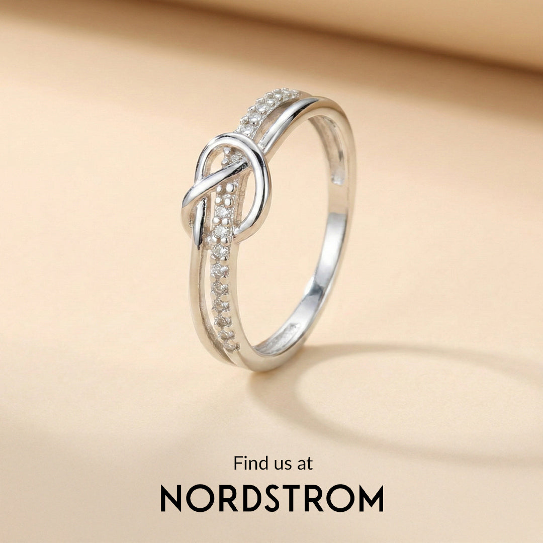 Silver ring with diamond accents on a beige background, Nordstrom branding visible.