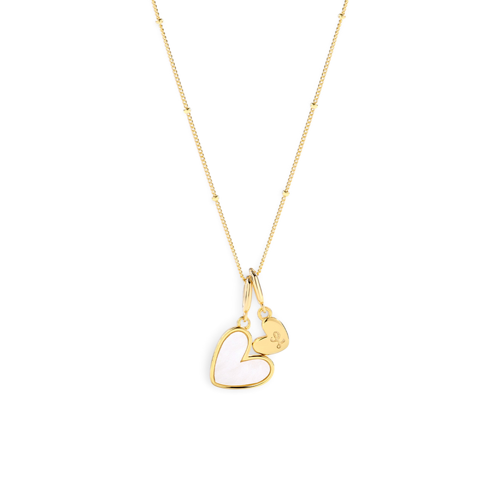 Gold heart-shaped necklace on a light gray background