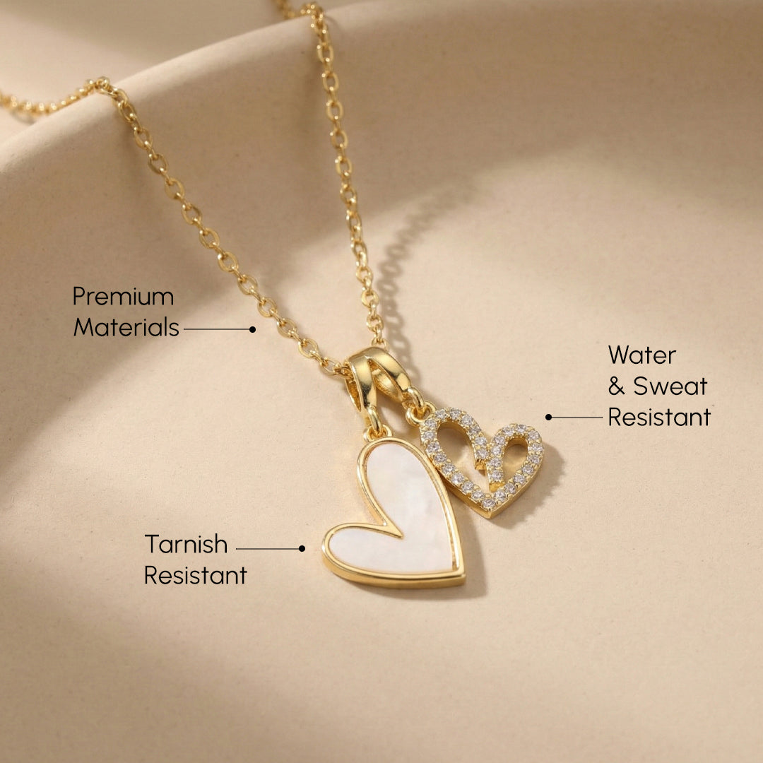 Gold necklace with heart pendant on a beige background