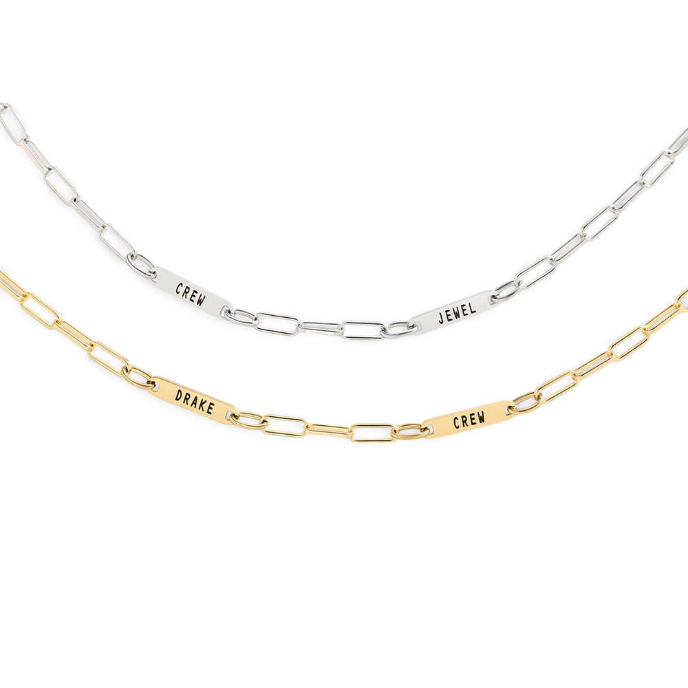Two necklaces with engraved names on a white background