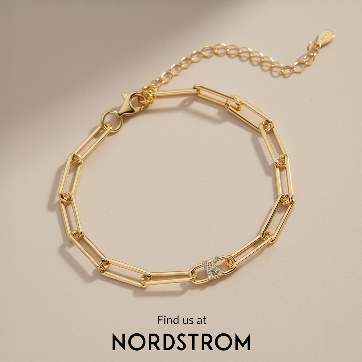Gold bracelet on a beige background with Nordstrom branding.