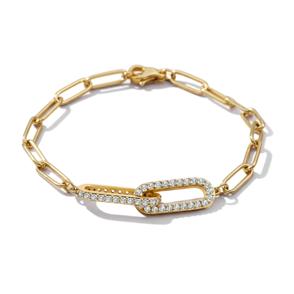 Gold chain bracelet with diamond accents on a light gray background