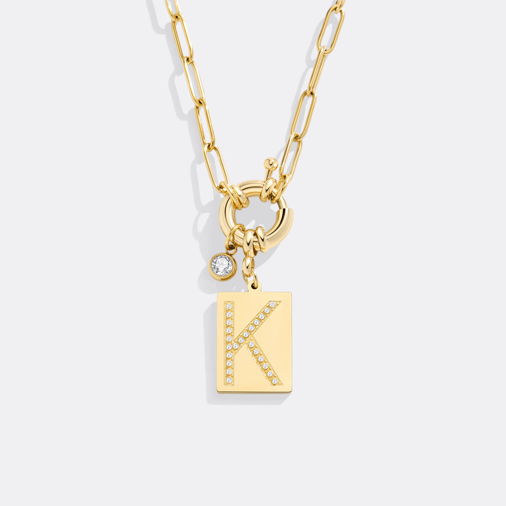 Gold necklace with a 'K' pendant on a white background