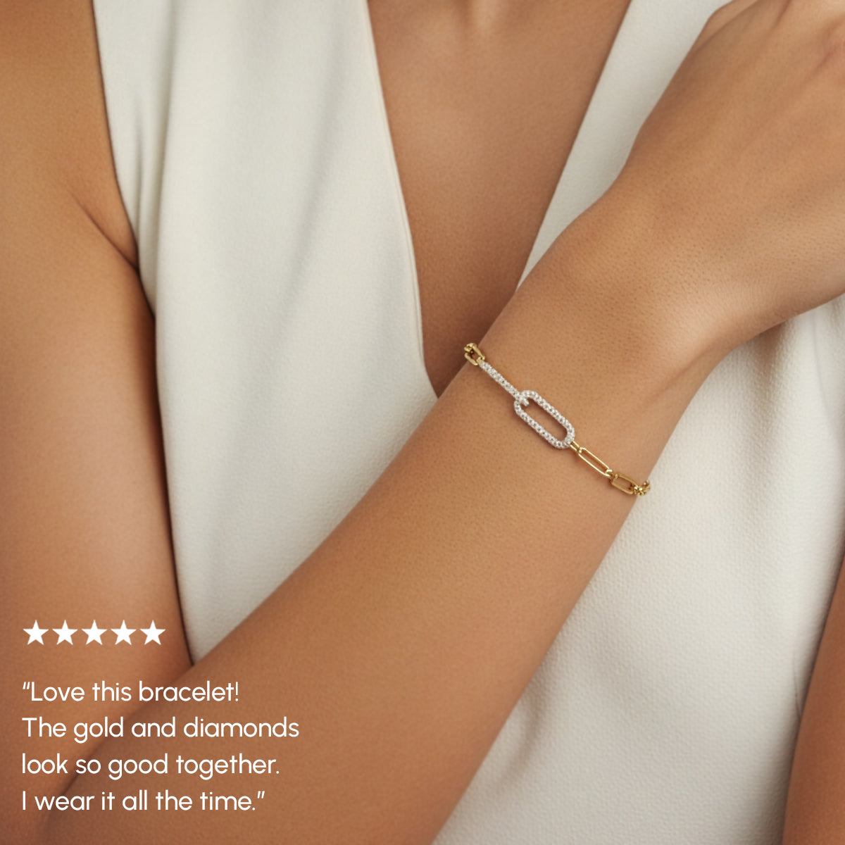 Gold bracelet with diamonds on a wrist, worn by a person against a neutral background.